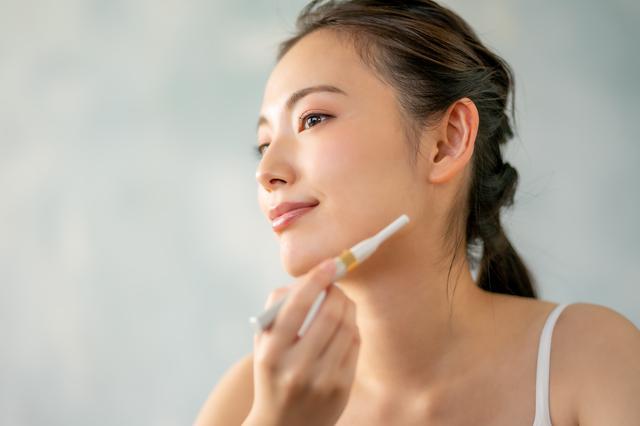 顔の自己処理をしている女性